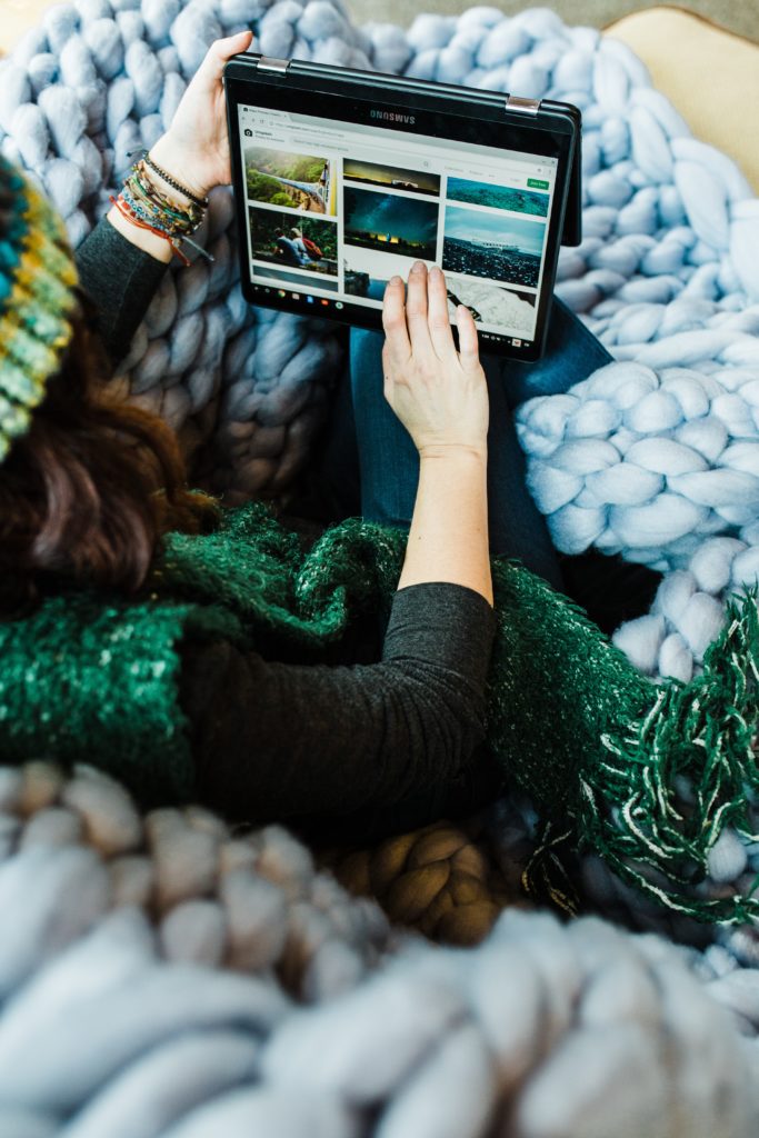 woman on a laptop under a blanket working from home