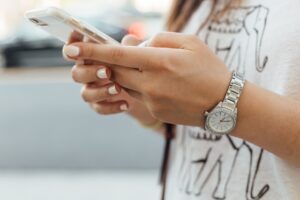 womans hands using a cell phone